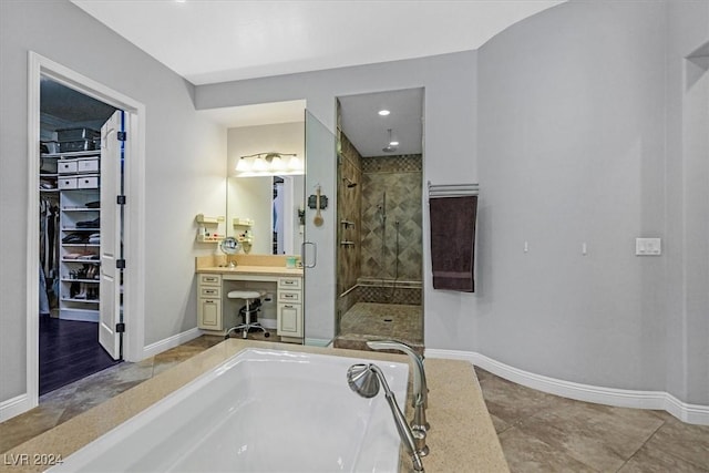 bathroom featuring tile patterned floors, vanity, and independent shower and bath