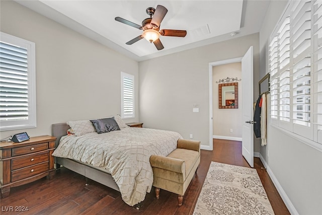 bedroom with ceiling fan and dark hardwood / wood-style floors