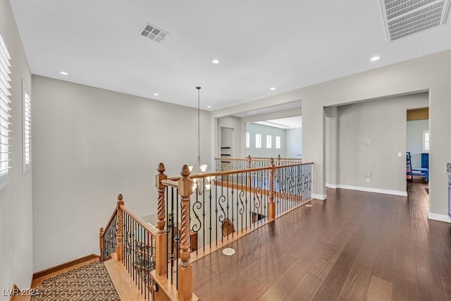 corridor with dark hardwood / wood-style flooring