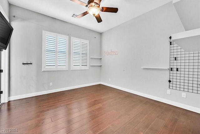 unfurnished room with dark hardwood / wood-style floors, vaulted ceiling, and ceiling fan