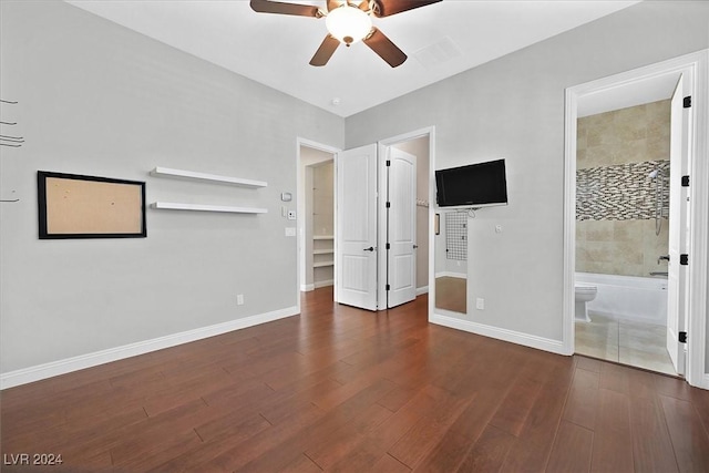 unfurnished bedroom featuring ensuite bathroom, ceiling fan, and dark hardwood / wood-style flooring