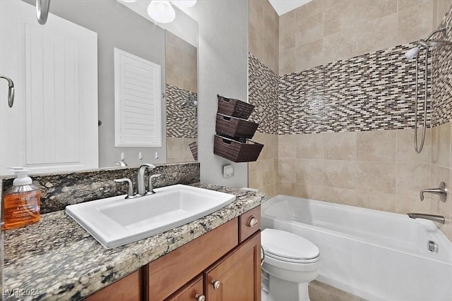 full bathroom with vanity, tiled shower / bath combo, and toilet