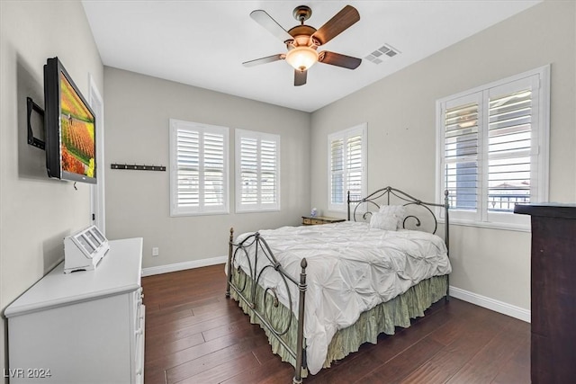 bedroom with ceiling fan and dark hardwood / wood-style floors