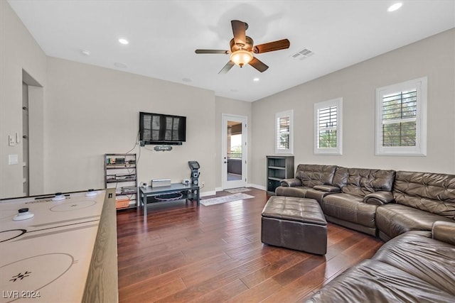 living room with ceiling fan and dark wood-type flooring