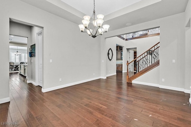 interior space with a notable chandelier and dark hardwood / wood-style flooring