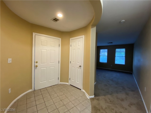 view of carpeted foyer entrance