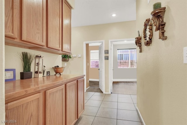 hall with light tile patterned floors