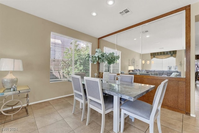 dining room featuring a healthy amount of sunlight and light tile patterned floors