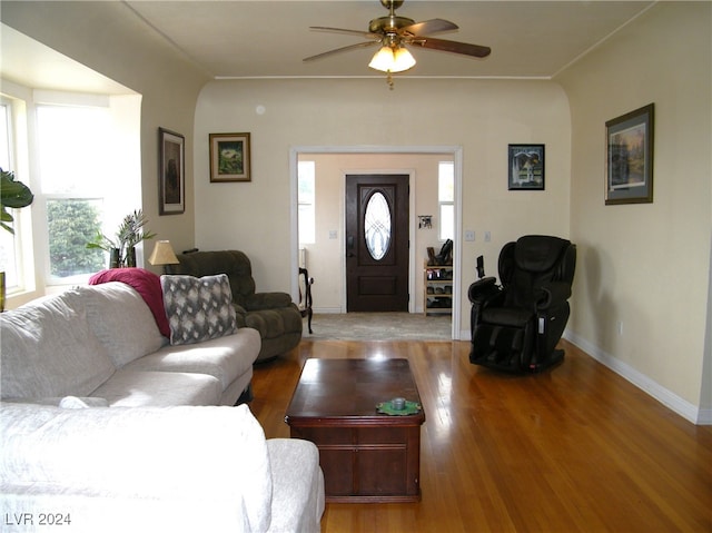 living room featuring hardwood / wood-style floors and ceiling fan