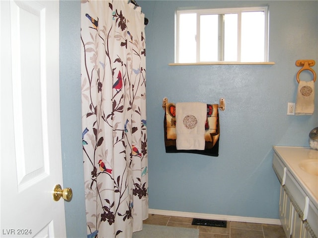 bathroom with vanity, a shower with shower curtain, and tile patterned floors