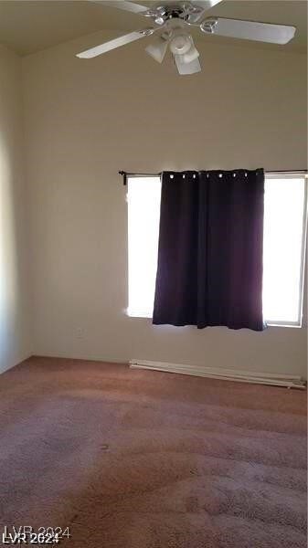 carpeted spare room with ceiling fan