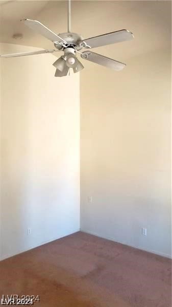 empty room featuring carpet floors and ceiling fan