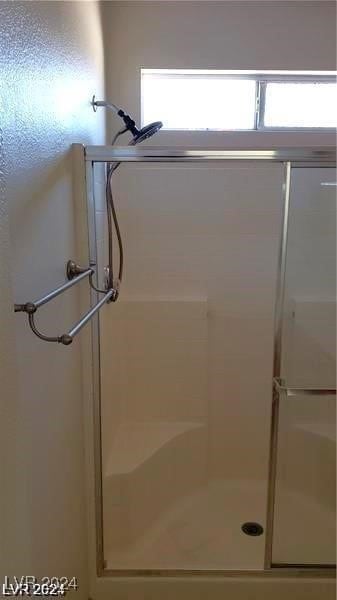 bathroom with a shower with shower door