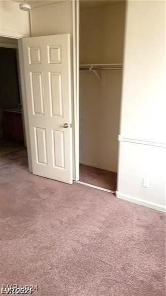 unfurnished bedroom featuring a closet and carpet