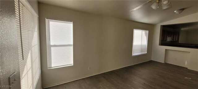 interior space featuring ceiling fan, dark hardwood / wood-style floors, and vaulted ceiling