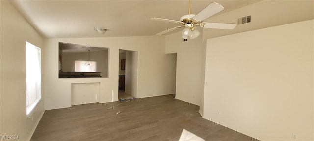 empty room featuring lofted ceiling, dark hardwood / wood-style floors, and ceiling fan