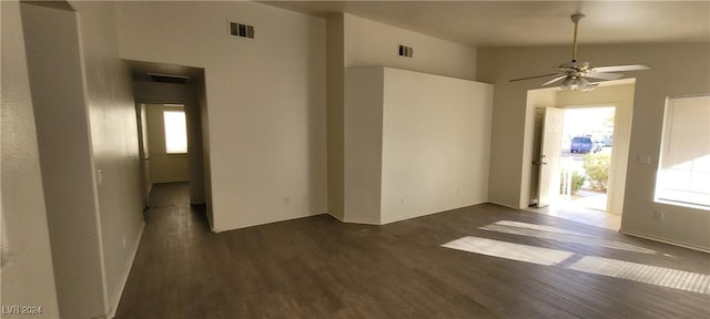 unfurnished room featuring vaulted ceiling, dark hardwood / wood-style floors, and ceiling fan