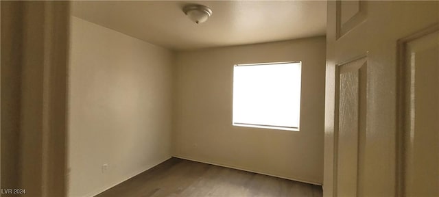 spare room with hardwood / wood-style floors