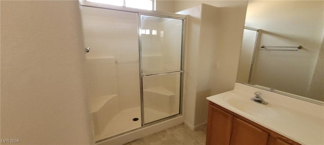 bathroom featuring an enclosed shower and vanity