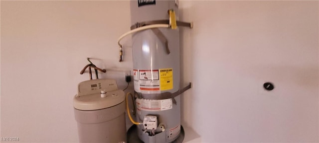 utility room featuring water heater