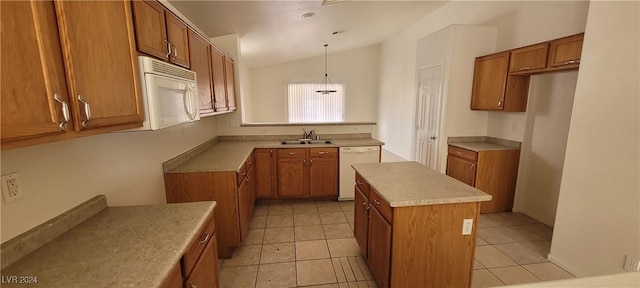 kitchen featuring sink, white appliances, hanging light fixtures, a kitchen island, and vaulted ceiling