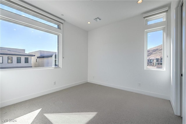 spare room featuring visible vents, baseboards, and recessed lighting