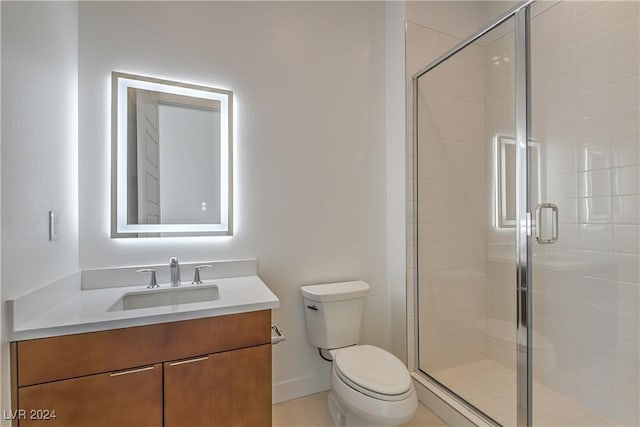 full bathroom with toilet, a shower stall, baseboards, and vanity