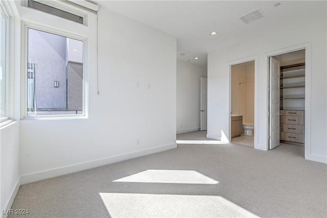 unfurnished bedroom with recessed lighting, light colored carpet, visible vents, and baseboards