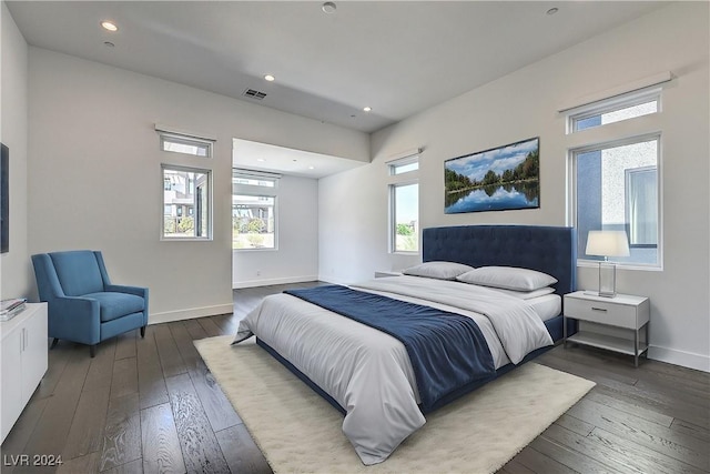 bedroom featuring hardwood / wood-style floors, recessed lighting, visible vents, and baseboards