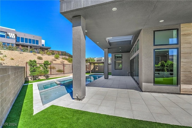 view of pool featuring a patio, a fenced backyard, and a pool with connected hot tub