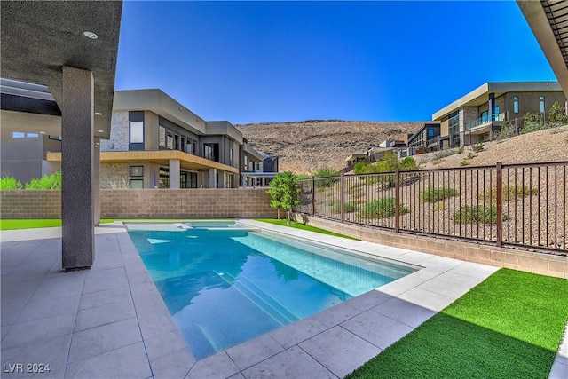 view of swimming pool featuring fence