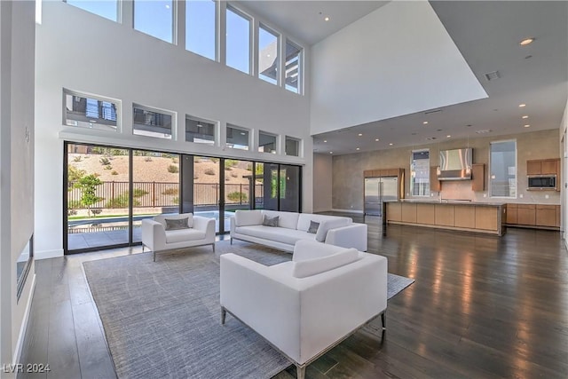 living room with recessed lighting, dark wood finished floors, visible vents, and baseboards