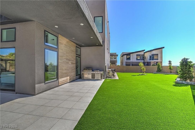 view of yard with a patio, area for grilling, and a fenced backyard