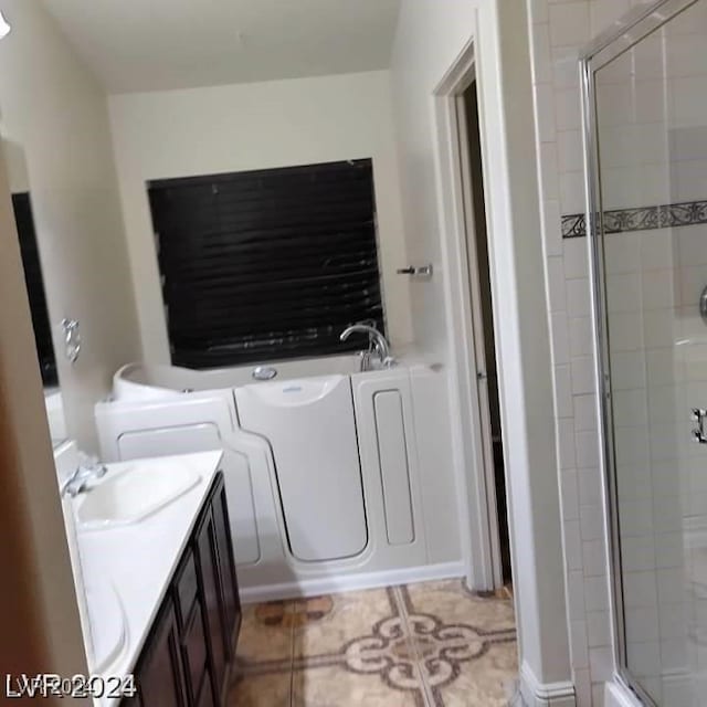 bathroom with vanity, an enclosed shower, and tile patterned floors