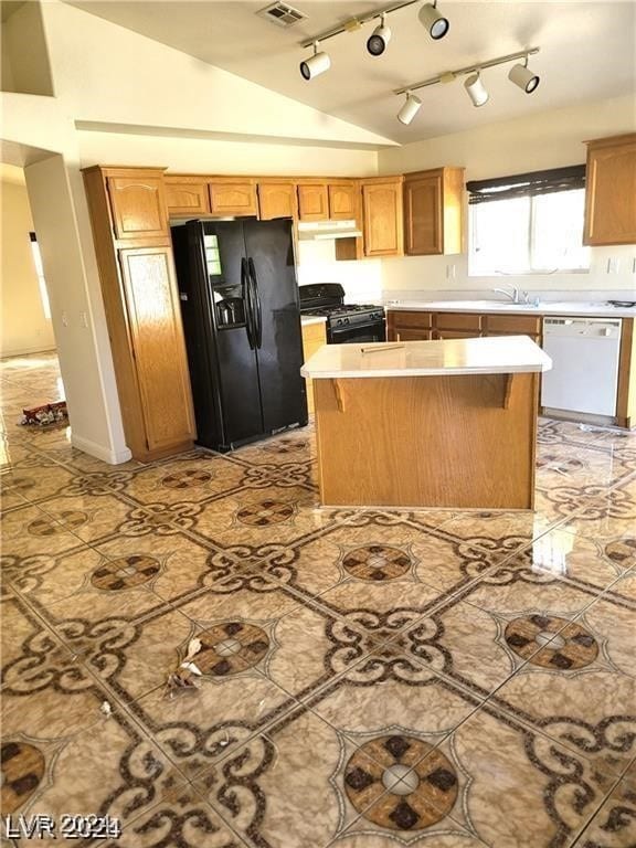 kitchen featuring rail lighting, a center island, black appliances, and vaulted ceiling