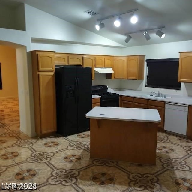 kitchen featuring black appliances, sink, a center island, rail lighting, and vaulted ceiling