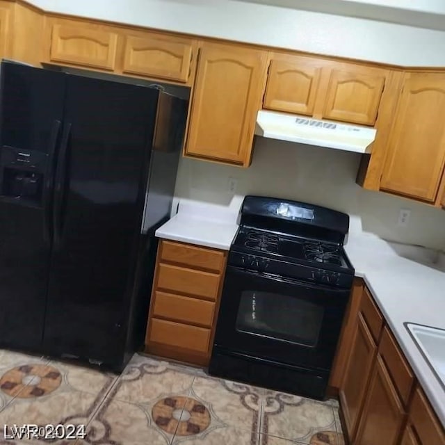 kitchen with light tile patterned flooring and black appliances