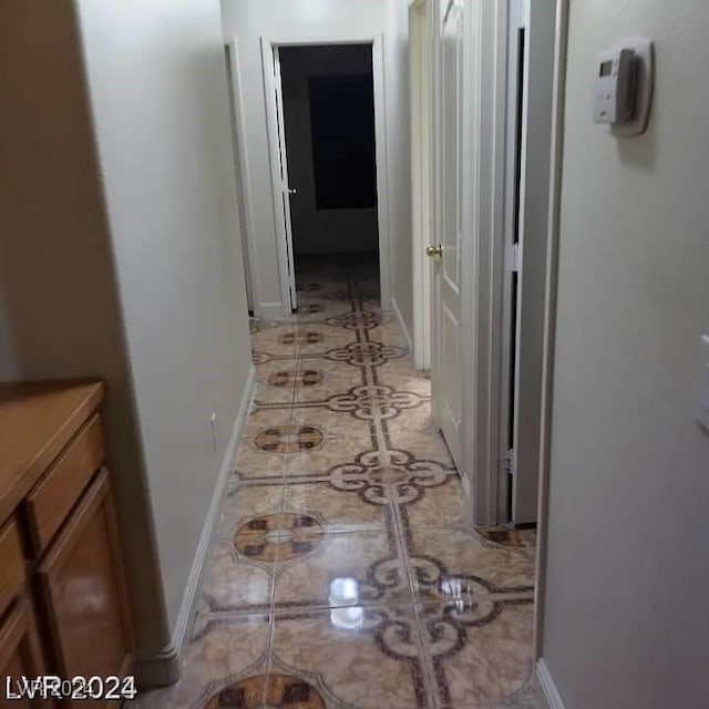 hallway featuring light tile patterned floors