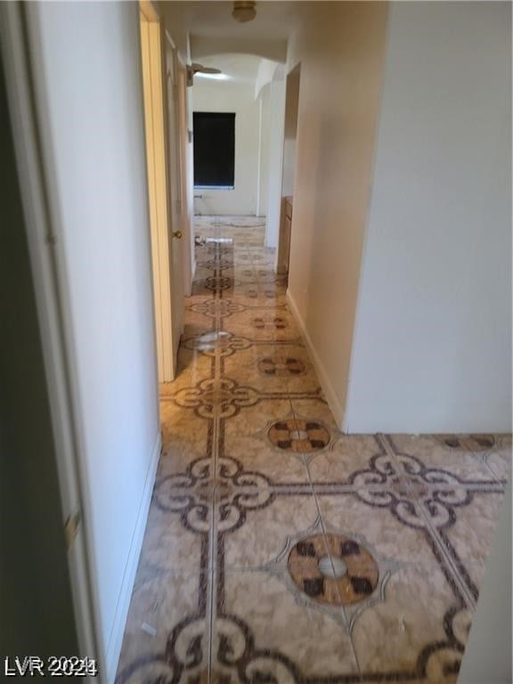 corridor featuring light tile patterned flooring