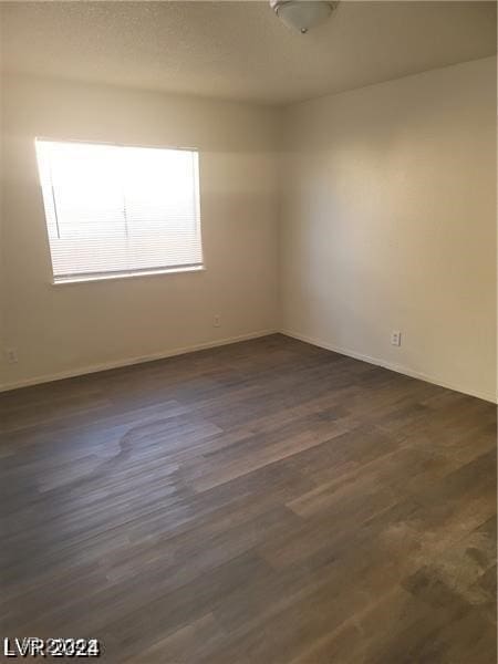 unfurnished room featuring dark hardwood / wood-style floors