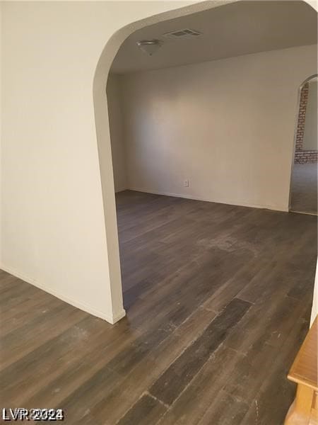 empty room featuring dark wood-type flooring