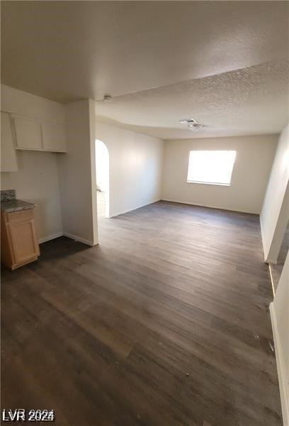 interior space featuring dark hardwood / wood-style flooring and a textured ceiling