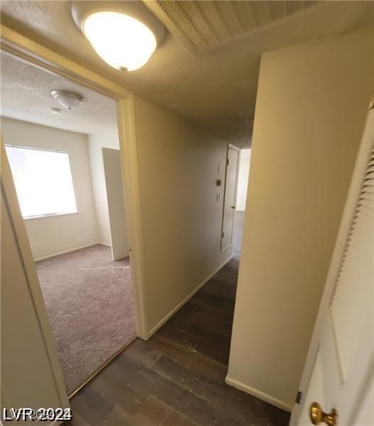 corridor featuring dark hardwood / wood-style flooring