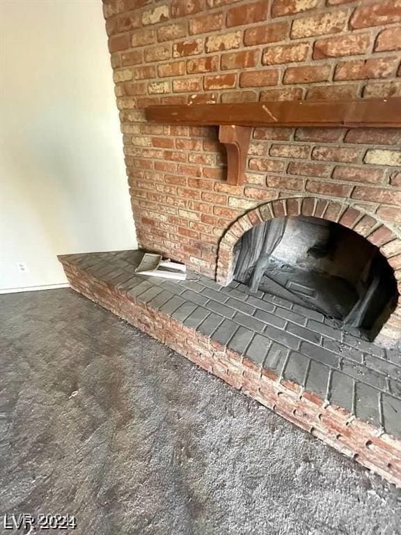 details featuring a brick fireplace and carpet flooring