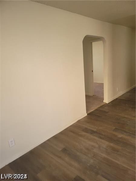 empty room featuring dark wood-type flooring