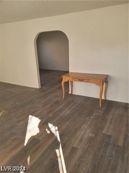 interior space featuring dark hardwood / wood-style floors and a textured ceiling