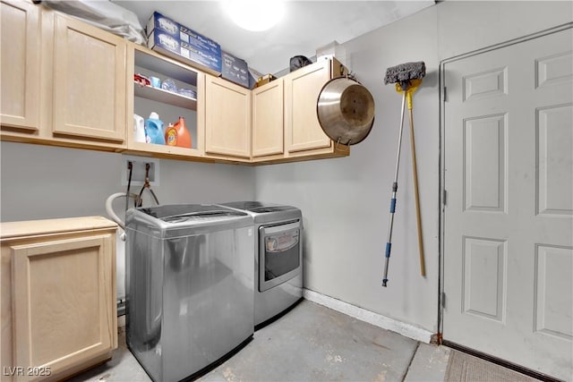 laundry room with cabinets and washing machine and clothes dryer