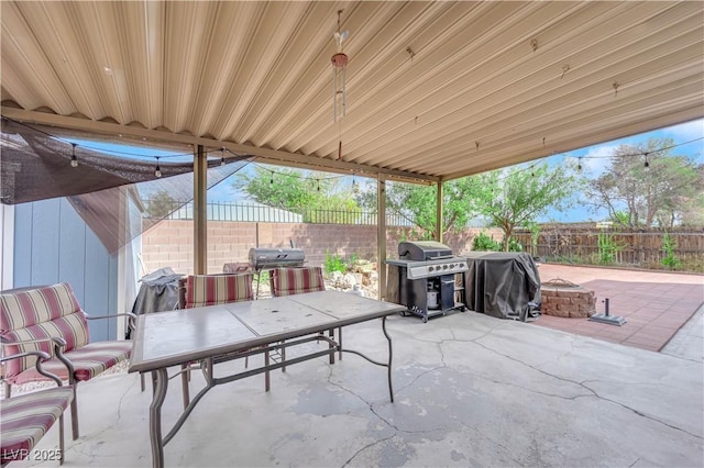 view of patio with grilling area and a fire pit