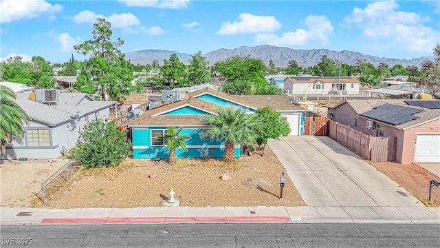 view of front of home with a garage and a mountain view