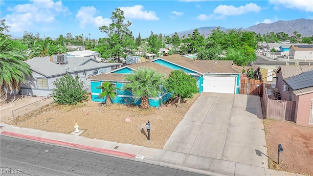 single story home featuring a mountain view and a garage